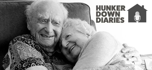 Centenarians, Joe Newman and Anita Sampson hugging in Sarasota, Florida.